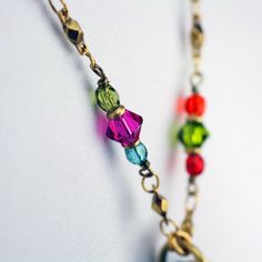 This heart hoop necklace embellished with a wide variety of multi-color Swarovski crystal and glass beads set into rainbow enamel placed on a chain beaded with Swarovski crystals and glass beads is inspired by it's own abstract and bright shape. This handmade piece is a one of a kind, fashionable statement necklace that will be perfect for any spring outfit or as a lovely gift for valentine's day. Pendant Length: 1.75 inches Pendant Width: 1.5 inches Necklace Length: 20.25 inches Additional Exte Bohemian Crystal Jewelry With Colorful Beads, Bohemian Crystal Jewelry With Faceted Beads, Bohemian Heart-shaped Jewelry With Faceted Beads, Multicolor Beaded Crystal Jewelry, Multicolor Crystal Jewelry With Colorful Beads, Multicolor Crystal Beaded Jewelry, Beaded Metal Jewelry For Accessorizing, Metal Beaded Jewelry For Accessorizing, Rainbow Beaded Czech Glass Jewelry