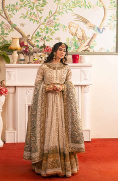 Pakistani Bridal Dress in Royal Pishwas Frock Style is a stunning attire that has the perfect balance of style and tradition. This trendy masterpiece in Pishwas Frock and Churidar style will give the gorgeous bride a head-turning flawless look on the most important day of her life. Pakistani Bridal Pishwas: Pakistani Bridal Pishwas Frock in an alluring white shade is emblazoned with ravishing embroidery, threads, and goldwork. Zari, sequins, and tilla make this beautiful Pishwas Frock an epitome of beauty and a perfect choice to wear on the nikkah day. Embellished borders and antique goldwork make this Pishwas Dress in silk fabric a stunning masterpiece. Churidar Pajama: The embellished Pishwas is paired with churidar, creating a lavish Nikkah Dress. The Churidar is perfectly stitched as p White Pishwas, Pakistani Bridal Lehenga, Wedding Dresses Pakistani, Bridal Mehndi Dresses, Pakistani Bridal Dress, Frock Style, Nikkah Dress, Salwar Dress, Pakistani Wedding Dress