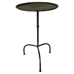 an iron table with a round top and metal legs, on a white background photo