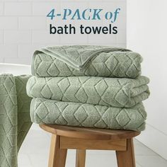 four towels stacked on top of each other with the words 4 pack of bath towels