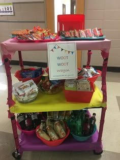 a cart filled with food and drinks on top of a floor next to a sign that says woot woot