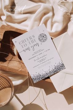 the wedding stationery is laid out on top of the table