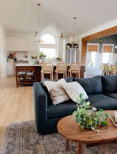 a living room filled with furniture and a wooden table