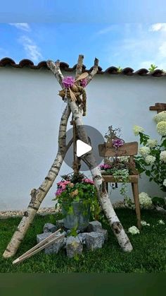 an outdoor sculpture made out of branches and flowers