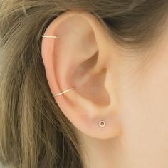 a close up of a person wearing a ear piercing