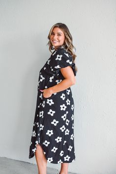 Enhance your wardrobe with our Floral Frenzy Midi Dress. Featuring charming floral smock details, this midi dress is available in both classic black and crisp white. Perfect for any occasion, this dress effortlessly combines style and comfort for a timeless look. Material: 70% Cotton 30% Polyester Care:Hand wash cold, do not bleach, hang or line dry. Available in both the Fort Wayne and North Manchester boutique locationsDon't forget! We're more than just a clothing boutique- we are a top-rated full-service florist operating in two locations. Need a floral delivery? Recently engaged? Or need flowers in a hurry? Check out our flowers tab for the full floral experience. Black Knee-length Floral Dress For Garden Party, Floral Midi Sundress For Daywear, Floral Print Midi Dress For Day Out, Casual Black A-line Floral Dress, Black Knee-length Dress For Garden Party, Black Floral Midi Dress For Spring, Black Floral Dress With Short Sleeves For Spring, Mid-length Floral Print Dress For Casual Occasions, White Knee-length Floral Dress