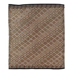 a brown and black square rug on a white background