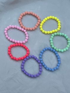 this pack of bracelets comes with 7 different colored bracelets. this bracelet is made up of solid color circular beads. they are homemade with love and care and are durable and child-proof. please do consider buying this product as well as my other bracelets/products to support my small business. thank you! Cheap Rainbow Round Beaded Bracelets, Aesthetic Bead Bracelet, Circular Aesthetic, Bracelets Rainbow, Color Bracelets, Homemade With Love, Strawberry Charm, Yellow Bracelet, Pink Clay