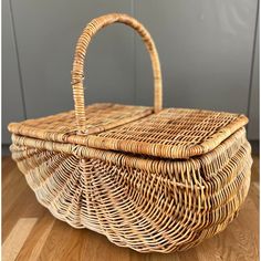 a wicker basket sitting on top of a wooden floor