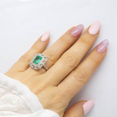 The Daphne ring was handmade in platinum and centers one natural Colombian emerald that weighs 2.70ctw which is surrounded by 76 old mine cut diamonds of H color and VS1 clarity that weigh 0.70ctw. This ring is currently size 7 and can be sized. Total weight: 6.3 grams/ 4dwt Ring measurement: 19mm by 16mm by 7mm Green Platinum Halo Ring With Center Stone, Green Emerald-cut Platinum Halo Ring, Green Emerald Cut Halo Ring In Platinum, Platinum Emerald Ring With Asscher Cut, Asscher Cut Emerald Ring With Platinum, Platinum Asscher Cut Emerald Ring, Platinum Emerald Ring With Baguette Cut And Halo Setting, Baguette Cut Emerald Ring With Halo Setting In Platinum, Silver Platinum Emerald Ring With Halo Setting