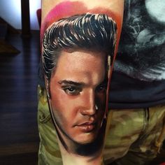 a man's arm with a portrait of elvis presley on it