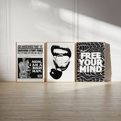 three framed posters on the wall in an empty room with wood flooring and white walls