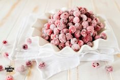 a white bowl filled with pink sprinkles on top of a table