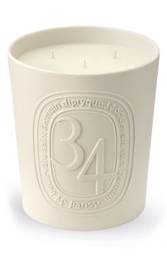 a white candle holder with the number 34 printed on it's front and sides