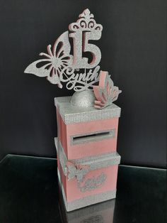 a pink box that has some silver decorations on it and the number 15 is in front of it