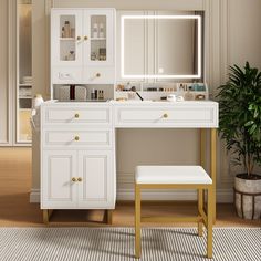 a white dressing table with a mirror and stool in front of it on top of a wooden floor