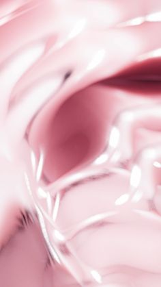 an abstract photograph of pink and white liquid