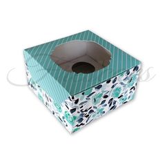 a blue and white patterned box with a hole in the middle on a white background