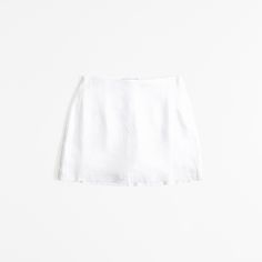 Ultra high rise mini skort in our soft linen-blend fabric, featuring a shorts lining for comfort and side zipper for a secure fit. White Mini Skort, Casual Mini Skirt With Short Inseam For Summer, Fitted Linen Shorts For Spring, Chic Short Inseam Mini Skirt For Summer, Chic Mini Skirt With Short Inseam For Summer, Chic Summer Mini Skirt With Short Inseam, Spring White Mini Skirt With Built-in Shorts, Chic Fitted Linen Mini Skirt, Summer Linen Skirt, Short Length