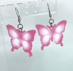 Beautiful, handmade holographic pink and white dangle butterfly earrings, made with resin and stainless steel. Pink Butterfly Charm Earrings, Pink Butterfly Charm Earrings As Gift, Pink Butterfly Charm Earrings For Gift, Pink Butterfly Earrings With Ear Wire, Trendy Pink Butterfly Jewelry, Trendy Pink Butterfly Earrings, Handmade Pink Butterfly Earrings, Butterfly Dangle Earrings, Handmade Butterfly