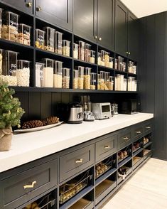 a kitchen filled with lots of black cabinets and counter top space next to a coffee maker