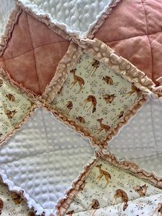 a close up of a quilt with animals on it