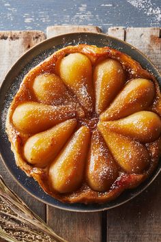 A plate with a full pear tarte tatin, puff pastry on the bottom and halved pears on top. Pear Tarte, Pear Tarte Tatin, Marcus Wareing, Tarte Tatin Recipe, Minimalist Food, The Best Desserts, Pear Tart, Pear Recipes, Candied Ginger