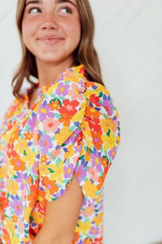 Unleash your dreamy side with our Dream Floral Top! Featuring a bright, multicolor floral print on a crisp white base, this top will add a pop of color to any outfit. The ruffle neck and ruched shoulder add a touch of charm to this playful piece. (It's perfect for a fun and flirty look!) Model is wearing a small and is 5'3" Plus model is wearing a 1X and is 5'8". Size Chart Length Bust S 24" 41" M 25" 43" L 25" 45" 1x 27" 50" 2x 28" 52" 3x 28" 54" *All measurements are approximate and done while Spring Floral Print Tops With Flutter Sleeve, Spring Floral Print Flutter Sleeve Blouse, Garden Party Floral Print Puff Sleeve Blouse, Puff Sleeve Floral Blouse For Garden Party, Garden Party Puff Sleeve Floral Blouse, White Printed Flutter Sleeve Tops, Spring Ruffle Sleeve Tops For Garden Party, Ruffle Sleeve Tops For Spring Garden Party, White Printed Tops With Flutter Sleeves