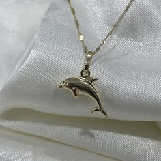 Ioka - Real 14K Gold Dolphin Necklace, Dainty Dolphin Charm Pendant with 0.9mm Singapore Chain, Sea Ocean Animal Jewelry ✅PENDANT SPECIFICATIONS: * Height: 0.51 in. (13 MM) * Width: 0.59 in. (15 MM) * Average Weight: 0.73 gr. ✅CHAIN SPECIFICATIONS: * Clasp: Spring-Ring   * Width: 0.9 MM ➤ Length: 16 inches   Avg Weight: 0.64 ➤ Length: 18 inches   Avg Weight: 0.71 ➤ Length: 20 inches   Avg Weight: 0.76 ➤ Length: 22 inches   Avg Weight: 0.83 ✅SHIPPING CONTENTS: *14K Gold Pendant & Chain *Complimen Penguin Necklace, Dolphin Charm, Ethereal Jewelry, Dolphin Pendant, Dolphin Jewelry, Dolphin Necklace, Gold Chain With Pendant, Jewelry Accessories Ideas, Jewelry Essentials