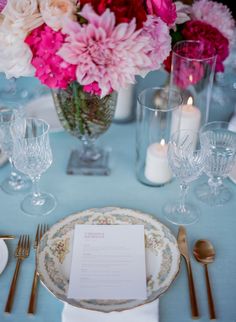 the table is set with pink and white flowers