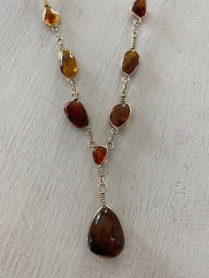 A handmade amber stone necklace made with 925 sterling silver wire.  Length 22 inch can be adjusted Adjustable Amber Wire Wrapped Jewelry, Baltic Amber Gemstone Necklaces, Adjustable Wire Wrapped Sterling Silver Necklace, Adjustable Sterling Silver Wire Wrapped Necklace, Handmade Baltic Amber Gold Necklaces, Amber Pendant Necklace In Baltic Amber, Baltic Amber Pendant Necklace, Gift Natural Stones Baltic Amber Necklaces, Adjustable Amber Citrine Necklace