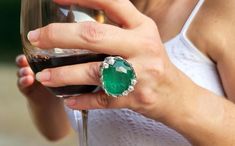 This exquisite vintage ring showcases a stunning large emerald doublet, accentuated by a brilliant array of diamonds. The centerpiece is a modified oval-shaped emerald, measuring an impressive 23.90 x 20.30 x 11.05 mm, with a captivating green color of medium saturation and semi-transparent clarity. Encircling the emerald are seventy-five round-shaped diamonds, est. 5.00 carat of full-cut, single-cut, and old European-cut diamonds, with a color grade of G-H and clarity ranging from VS2 to SI1, creating a dazzling halo that enhances the ring's overall brilliance. An emerald doublet is a composite stone made by fusing a genuine, natural emerald with a durable backing, often using a layer of synthetic material to enhance its appearance and strength. This technique allows the beauty of the nat Evening Diamond Ring With Gemstone, Elegant Oval Diamond Ring For Party, Luxury Emerald Ring With Rose Cut Diamonds For Anniversary, Elegant Green Evening Rings, Luxury Emerald Ring With Rose Cut Diamonds, Luxury Green Emerald Ring With Rose Cut Diamonds, Formal Round Emerald Diamond Ring, Emerald Ring With Rose Cut Diamonds For Formal Occasions, Luxury Emerald Ring With Single Cut Diamonds For Anniversary