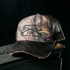 Looking for a super stylish and practical hat that will keep you cool in the summer and warm in the winter? Look no further than the Grunt Style Realtree Xtra GS Embroidered Logo Flag Hat! This chino twill cap features a 6-panel design with a soft mesh back and an embroidered Grunt Style logo on the front. The plastic snapback closure ensures a perfect fit, while the Realtree Xtra camouflage print keeps you looking sharp whether you're out in the woods or just running errands around town. So don't just put any old hat on your head - step up your style game with the Grunt Style Realtree Xtra GS Embroidered Logo Flag Hat! Shop our entire Grunt Style Collection Here Product Info This hat is a structured 6 panel chino twill Realtree Xtra® Camo/soft mesh back Cap with an embroidered Grunt Style Outdoor Cotton Trucker Hat, Snapback Visor Hat With Letter Print For Outdoor, Casual Trucker Hat With Letter Print For Outdoors, Cotton Trucker Hat With Visor For Outdoor, Outdoor Snapback Hat With Letter Print And Curved Brim, Outdoor Cotton Trucker Hat With Visor, Winter Flat Brim Trucker Hat For Outdoor, Winter Outdoor Trucker Hat With Flat Brim, Outdoor Brown Snapback Hat With Letter Print