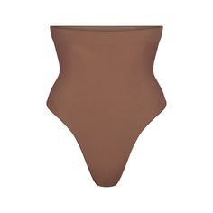 Wear this perfectly stretchy, shapewear high-waisted thong for a flat tummy and cinched waist without bulk or panty lines. Features a high waist fit that hits right below the bust, an interior silicone underband to prevent roll-down, a cotton gusset, and a wide crotch for added coverage. Fits true to size. | SKIMS High-Waisted Thong | Medium Neutral | Seamless Sculpt Shapewear Thong, Best Shapewear, Flat Tummy, Cinched Waist, Shapewear, High Waist, Lounge Wear, High Waisted, How To Wear