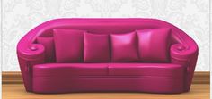 a pink couch sitting on top of a hard wood floor