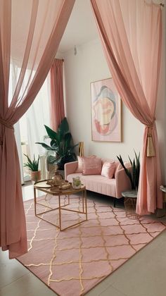 a living room filled with furniture and pink curtains