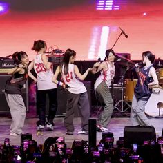 group of young people dancing on stage with musical instruments