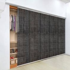 an open closet with clothes and shoes on the shelves next to sliding doors that are closed