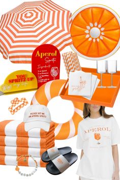 an orange and white striped umbrella, beach towels, flip flops, hat, towel rack, and other items