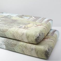 two bedspreads with winnie the pooh print on them are laying side by side