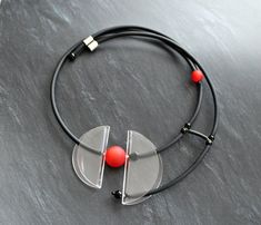 Asymmetric necklace for lovers of large jewelry. Stylish necklace , created from a transparent Lucite disc, two red beads of different sizes, black rubber . In the options you can choose the color of the beads, which I can replace with another suitable color for you. I also propose to create a bracelet, ring and earrings to this necklace, you only need to write me a letter and you will become the owner of unique handmade jewelry :-) Modern Round Lucite Jewelry, Modern Red Adjustable Necklace, Modern Black Necklaces For Jewelry Making, Modern Black Glass Jewelry, Modern Circle Necklace With Adjustable Fit, Modern Handmade Clear Necklaces, Black Glass Necklaces, Black Round Glass Necklaces, Mesh Necklace