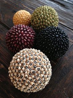 four different types of balls sitting on top of a wooden table