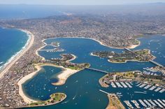 an aerial view of a city and harbor with lots of boats in the bay area