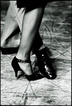 black and white photograph of woman's legs wearing high heels