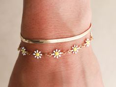 The most anticipated chain from our followers! The Daisy chain is made up of adorable, enamel coated daisies in pink, white, or the colorful multi. This bracelet stacks well with other chains in our shop or looks great worn by itself, we love it with the dot, herringbone and pearl bracelets. Bracelets come with an extender for an adjustable fit. Made with waterproof materials - 18k gold electroplated stainless steel, 14k gold filled clasp and extenders.Lengths: 5" + 1" extender (child)6" + 1" ex White Spring Jewelry For Friendship, Everyday Daisy-shaped Jewelry For Spring, Everyday Daisy-shaped Spring Jewelry, Trendy Daisy-shaped Spring Jewelry, Cute White Bracelets For Spring, Cute Spring Bracelet Jewelry, Trendy White Daisy Shaped Jewelry, Trendy White Daisy-shaped Jewelry, Dainty White Chain Bracelet With Extender