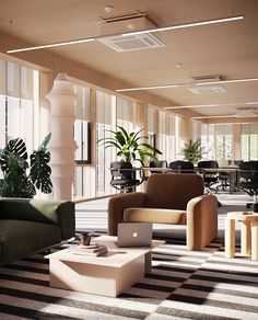 an office with couches, chairs and tables in it