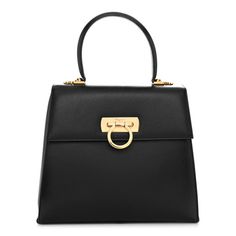 This is an authentic SALVATORE FERRAGAMO Hammered Calfskin Medium Iconic Top Handle Bag in Black. This chic shoulder bag is finely crafted of black leather. The bag features a rolled top handle, a frontal flap, and a Ferragamo ring clasp closure. This opens to a black fabric interior with a zipper pocket. Calf Leather Bag With Branded Hardware For Daily Use, Calf Leather Top Handle Bag With Gold-tone Hardware, Top Handle Calf Leather Bag With Gold-tone Hardware, Calf Leather Bag With Gold-tone Hardware Top Handle, Formal Calf Leather Bag With Gold-tone Hardware, High-end Calf Leather Bags With Gold-tone Hardware, Luxury Handheld Flap Bag With Gold-tone Hardware, Top Handle Flap Bag With Gold-tone Hardware For Shopping, Office Bags With Branded Hardware In Calf Leather