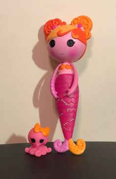 there is a toy mermaid and her baby doll