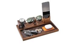 a wooden tray with sunglasses, watch, cell phone and other items sitting on it