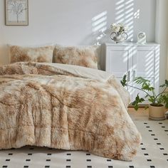 a bedroom with a bed covered in fur and pillows